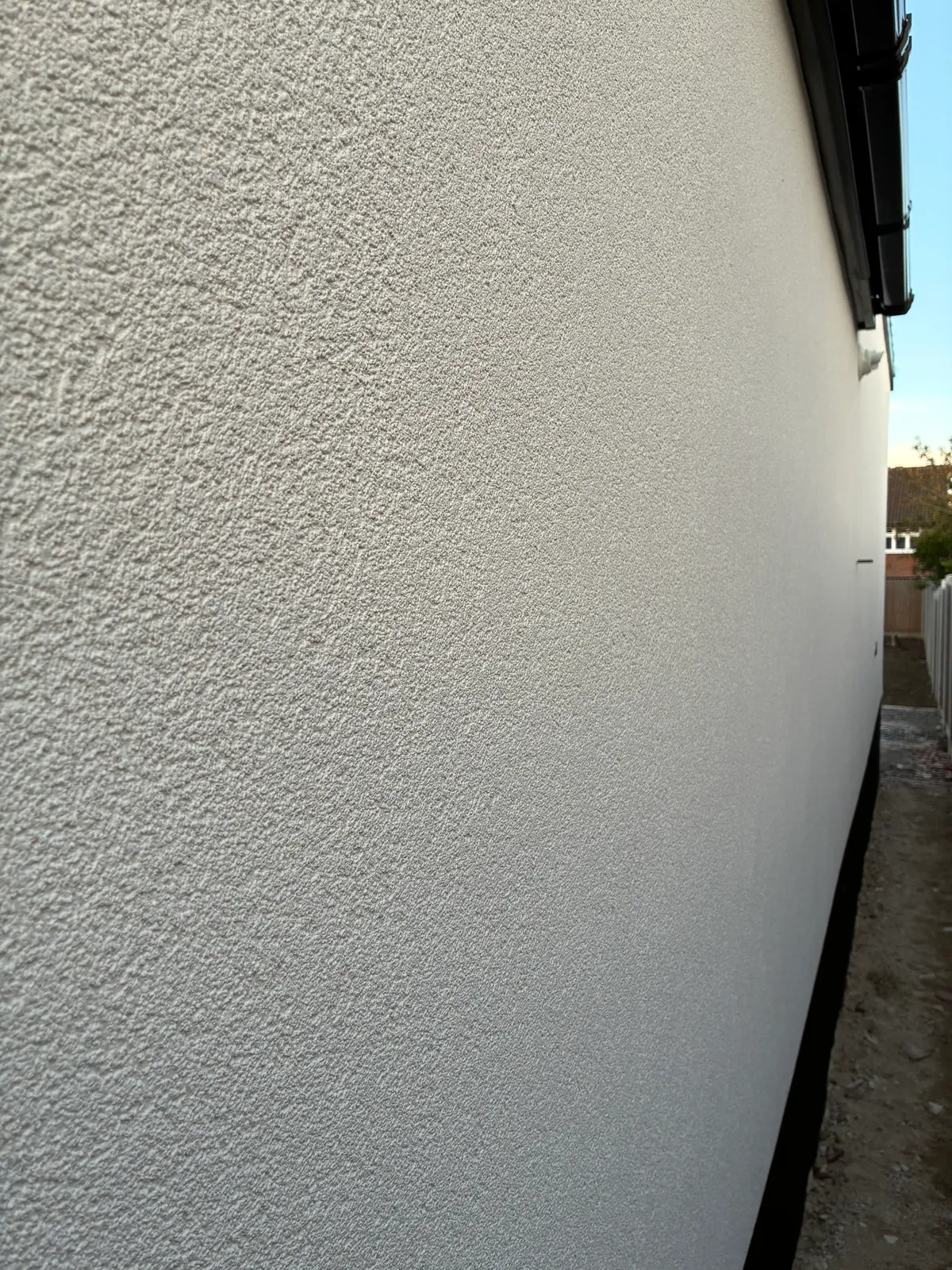 Close-up of a white textured rendered exterior wall